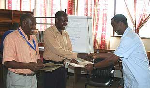 Mr. A. Ndosi Course Coordinator and Mr. L. Mtalo Academic Officer, presenting certificates